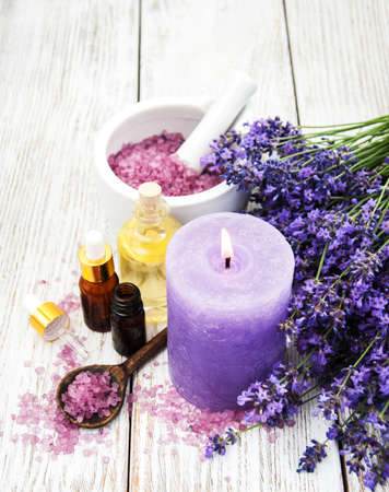 Spa products with lavender flowers on a tableの写真素材