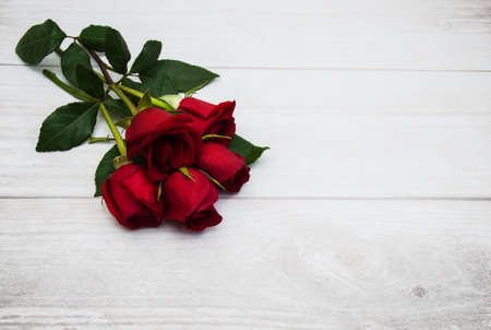 Bouquet of red  roses on a old wooden backgroundの写真素材