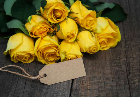 Yellow roses on a old wooden tableの写真素材