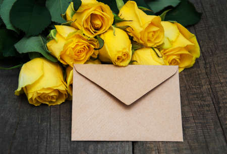 Yellow roses on a old wooden table