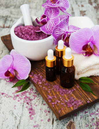 Spa and massage products with orchids on a old wooden backgroundの写真素材