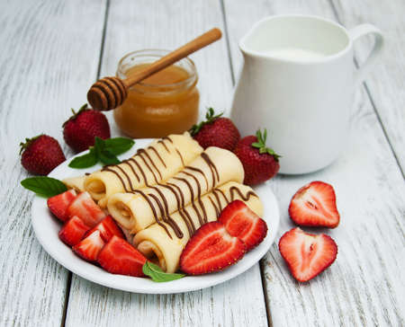 pancakes  with strawberries  and chocolate sauceの写真素材