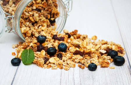 Homemade  granola in jar on a old wooden  tableの写真素材