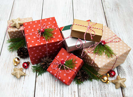 Christmas gift box and decorations on wooden background