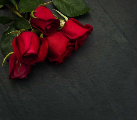 Bouquet of red  roses on a black stone  backgroundの写真素材