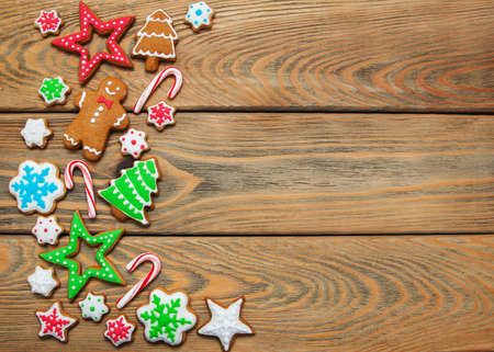 Christmas ginger and honey colorful cookies on a old wooden table