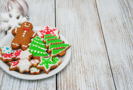Christmas ginger and honey colorful cookies on a old wooden tableの写真素材