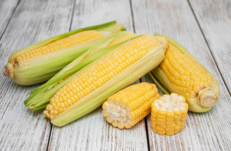 Fresh corn on the cob on wooden tableの写真素材
