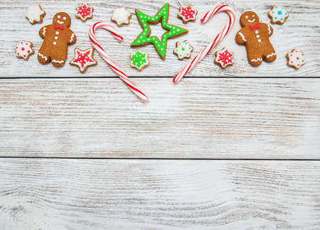 Christmas ginger and honey colorful cookies on a old wooden tableの写真素材