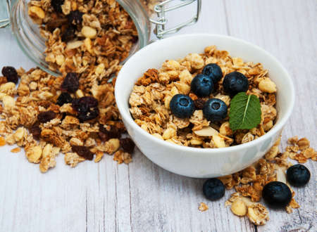 Bowl with granola and blueberries on a table