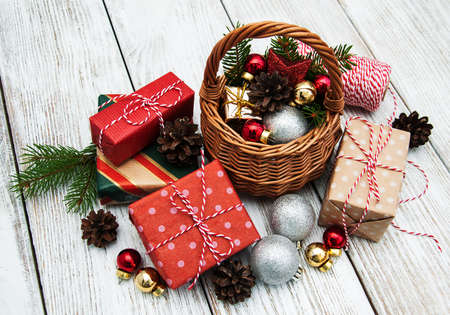 Christmas baubles in basket on wooden table