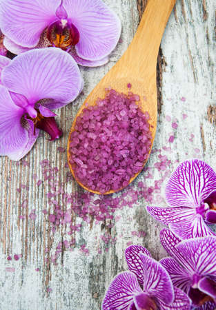 Spa salt and orchids on a old wooden backgroundの写真素材