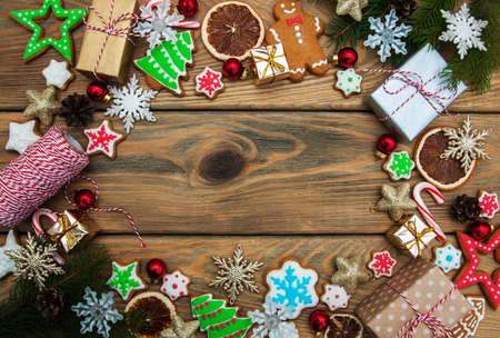 Christmas ginger and honey colorful cookies with fir tree branchesの写真素材