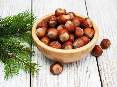 Bowl with hazelnuts on a old wooden tableの写真素材