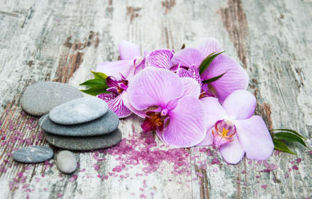 Spa and massage products with orchids on a old wooden backgroundの写真素材