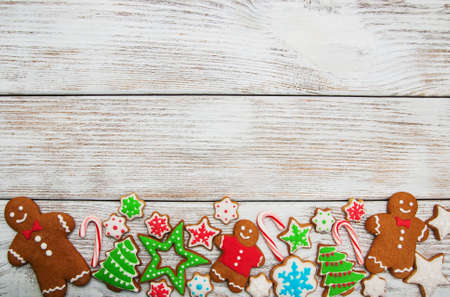 Christmas ginger and honey colorful cookies on a old wooden tableの写真素材