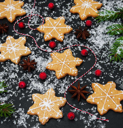 Christmas ginger and honey cookies on a black stone background