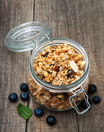 Homemade  granola in jar on a old wooden  tableの写真素材
