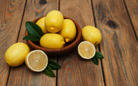 Fresh ripe lemons on a old wooden tableの写真素材
