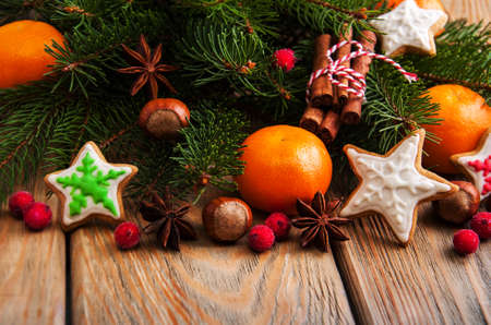 Christmas gingerbread cookies and tangerines on a wooden backgroundの写真素材