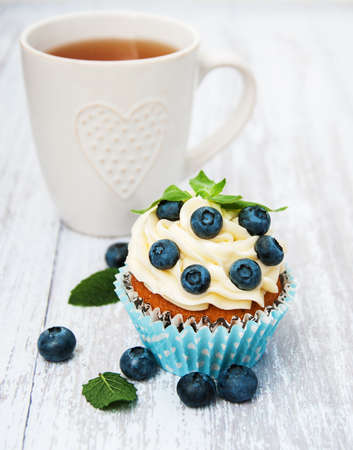 Cupcake with fresh blueberries on a old wooden tableの写真素材