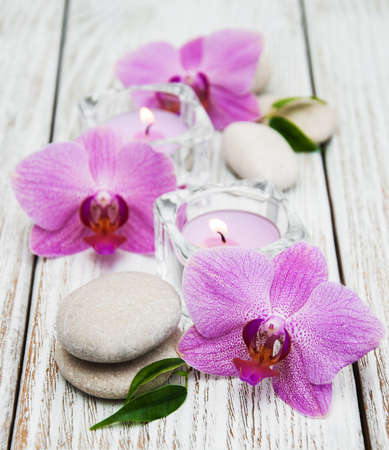 Spa concept with pink orchids, candles and massage stonesの写真素材