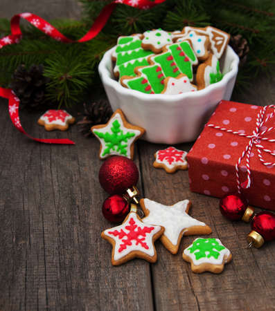Christmas ginger and honey colorful cookies on a old wooden tableの写真素材