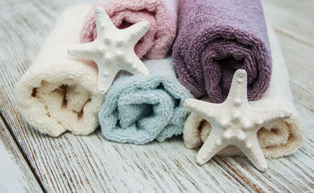 Spa towels and starfis on a old wooden tableの写真素材