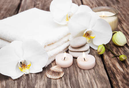 Spa products with white orchids flowers on a tableの写真素材