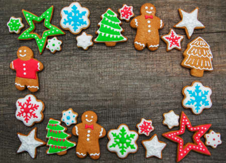 Christmas ginger and honey colorful cookies on a old wooden table