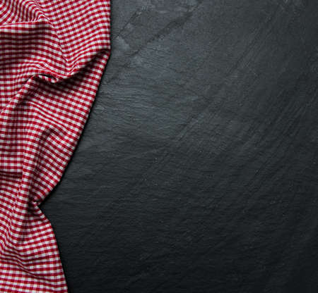 Checkered napkin on a black stone background