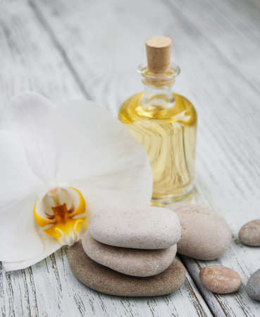 Spa products and white orchids on a old wooden tableの写真素材