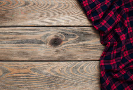 Checkered napkin on a old brown wooden  backgroundの写真素材