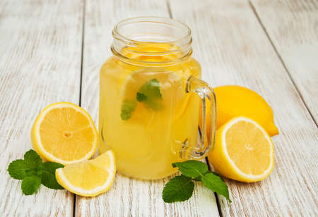 Jar with lemonade on a old wooden tableの写真素材