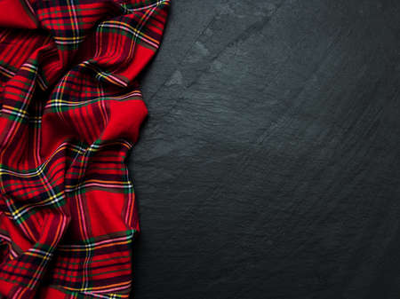Checkered napkin on a black stone backgroundの写真素材