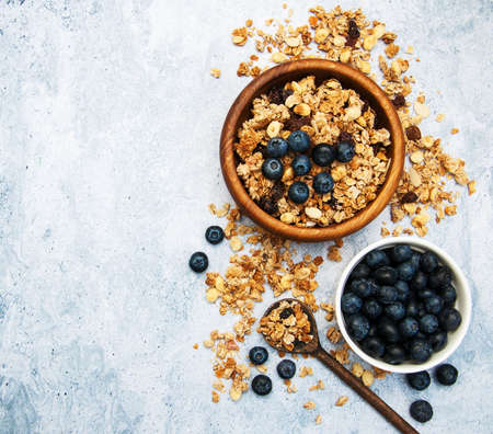 Bowl with granola and blueberries on a table