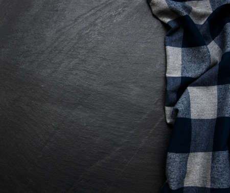 Checkered napkin on a black stone backgroundの写真素材