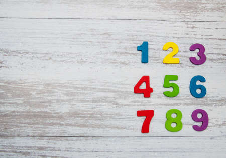 colorful wooden numbers on a old wooden background