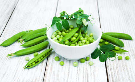 green peas  on rustic white wooden backgroundの写真素材