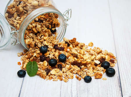 Homemade  granola in jar on a old wooden  tableの写真素材