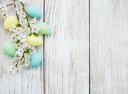 Easter eggs and spring  blossom on a old wooden background