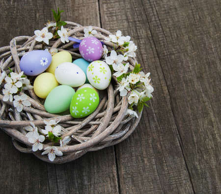 Easter eggs and spring  blossom on a old wooden background