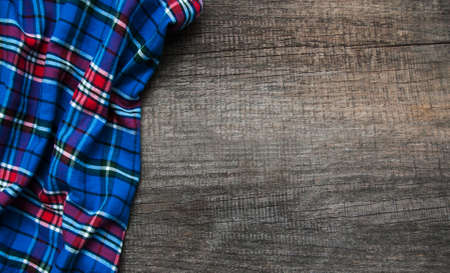 Checkered napkin on a old brown wooden backgroundの写真素材