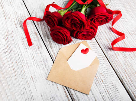 Envelope with roses and heart on a wooden  backgroundの写真素材