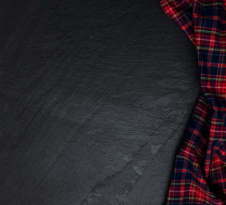 Checkered napkin on a black stone backgroundの写真素材
