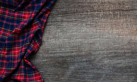 Checkered napkin on a old brown wooden  backgroundの写真素材