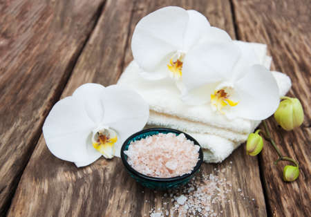Spa products with white orchids flowers on a tableの写真素材