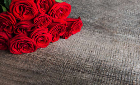 Red roses on a old wooden backgroundの写真素材