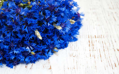 blue cornflowers on a old white wooden backgroundの写真素材
