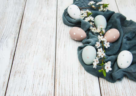 Easter eggs and spring  blossom on a old wooden background